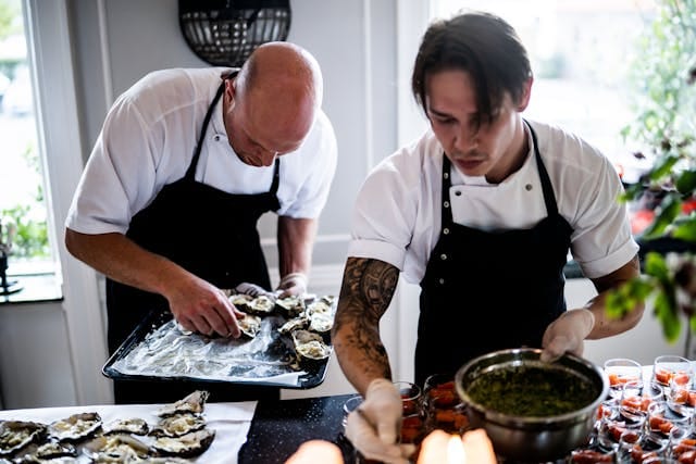 Two Chefs Preparing a Seafood Dish